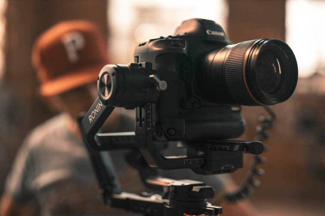 Camera operator filming with a professional broadcast camera